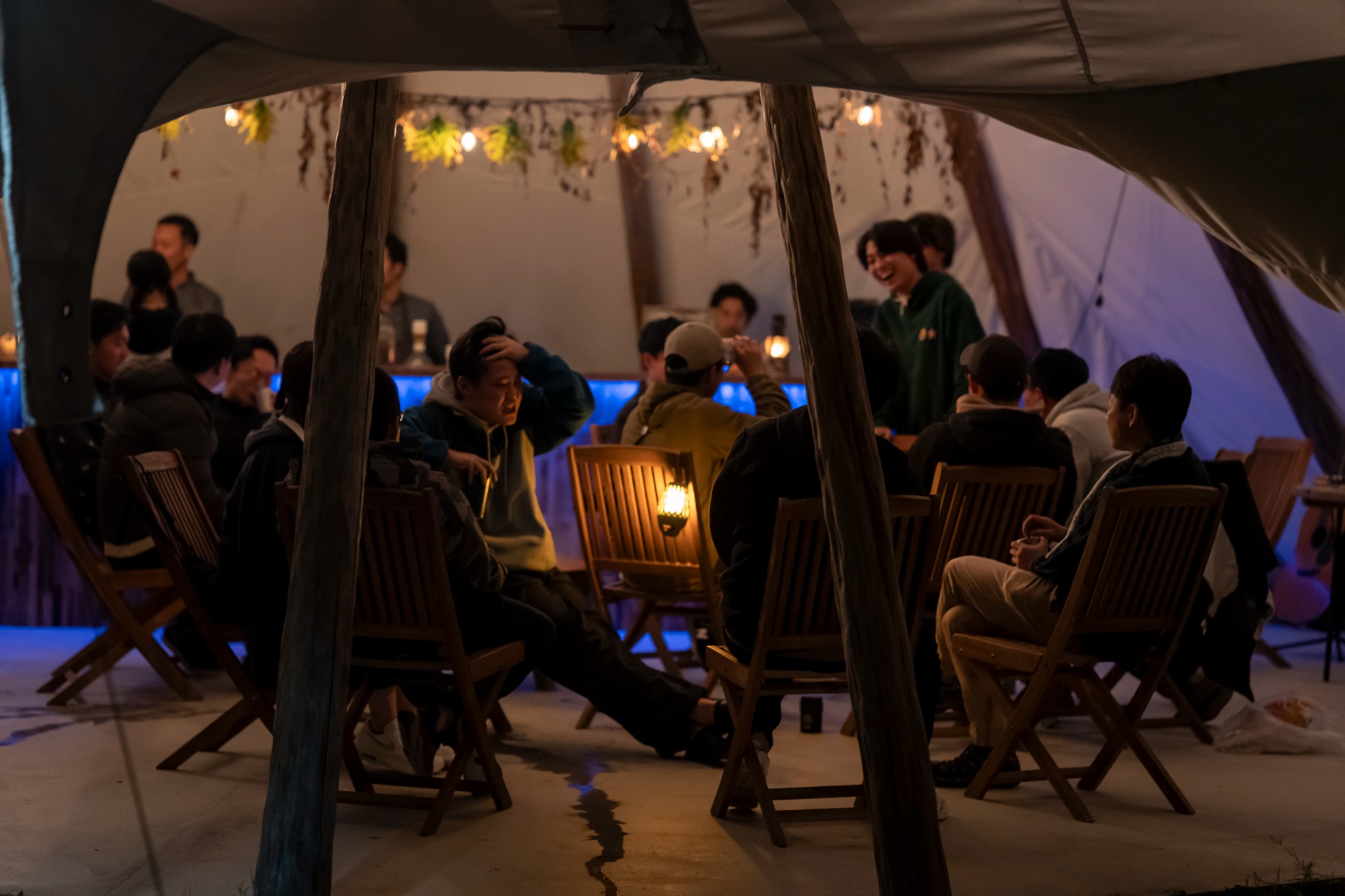 Guests socialising inside the venue yurt at night